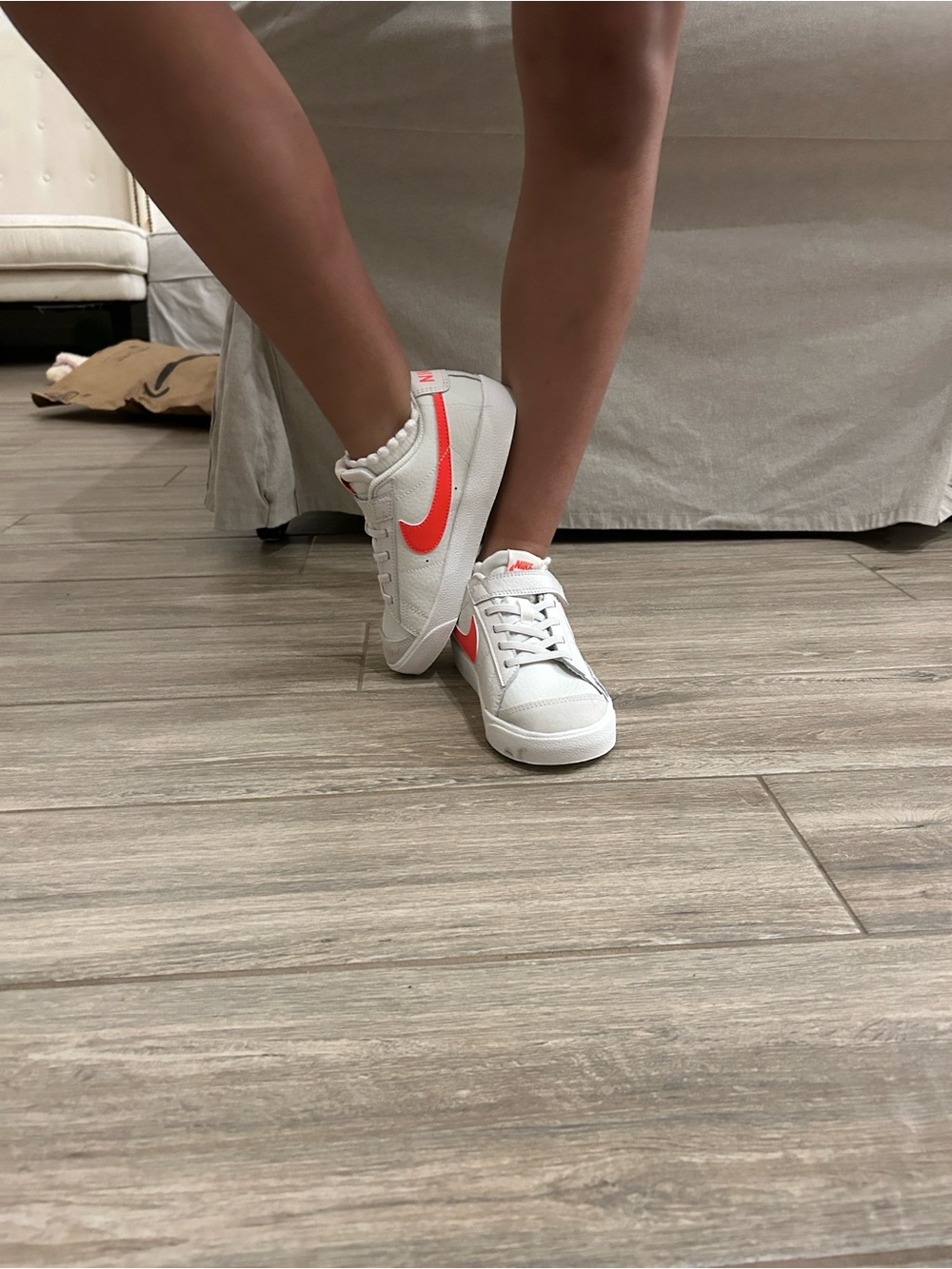 Nike Women’s White Sneakers with Coral Swoosh Accent